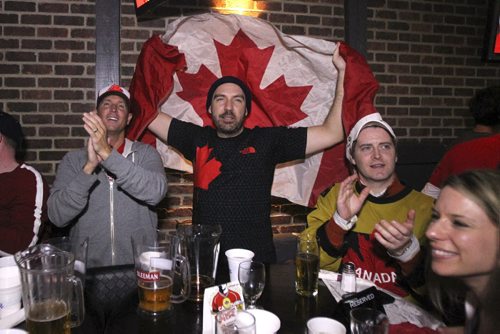 Fans at the Confusion Bar & Grill cheer after Canada scores its third goal during the Olympic Men's Hockey Gold medal game between Canada (3) and Sweden (0) Sunday morning. 140223 - Sunday, February 23, 2014 -  (MIKE DEAL / WINNIPEG FREE PRESS)