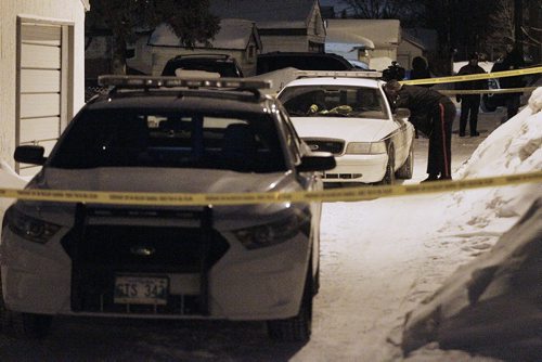 February 23, 2014 - 140223  -  Police investigate at 611 Harbison Ave. east in Winnipeg Sunday, February 23, 2014. There are reports that a male was found dead in the backyard. John Woods / Winnipeg Free Press