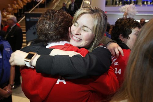 February 24, 2014 - 140224  -  Olympic curling gold medalists Jennifer Jones (skip), Kaitlyn Lawes (third), Jill Officer (second), Dawn McEwen (lead), Kirsten Wall (alternate) and their coach Janet Arnott return to hundreds of family and supporters at the Winnipeg Airport Monday, February 24, 2014.  John Woods / Winnipeg Free Press