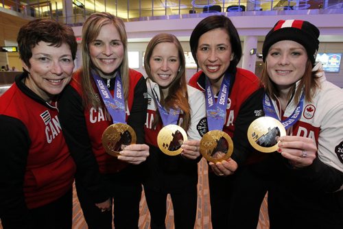 February 24, 2014 - 140224  -  Olympic curling gold medalists Jennifer Jones (skip), Kaitlyn Lawes (third), Jill Officer (second), Dawn McEwen (lead), and their coach Janet Arnott (L) return to hundreds of family and supporters at the Winnipeg Airport Monday, February 24, 2014.  John Woods / Winnipeg Free Press
