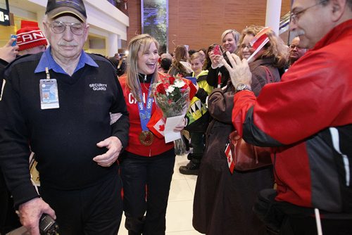 February 24, 2014 - 140224  -  Olympic curling gold medalists Jennifer Jones (skip), Kaitlyn Lawes (third), Jill Officer (second), Dawn McEwen (lead), Kirsten Wall (alternate) and their coach Janet Arnott return to hundreds of family and supporters at the Winnipeg Airport Monday, February 24, 2014.  John Woods / Winnipeg Free Press
