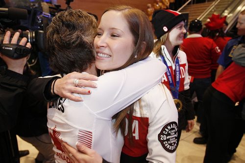 February 24, 2014 - 140224  -   Olympic curling gold medalist Kaitlyn Lawes is greeted by her mother as she and Jennifer Jones (skip), Jill Officer (second), Dawn McEwen (lead), Kirsten Wall (alternate) and their coach Janet Arnott return to hundreds of family and supporters at the Winnipeg Airport Monday, February 24, 2014.  John Woods / Winnipeg Free Press