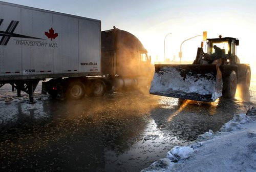 A semi trailer stuck on the ice from a large water main break in the south bound lanes of Route 90 at Selkirk Ave. on a -25C Tuesday morning.  Wayne Glowacki / Winnipeg Free Press Feb. 25   2014