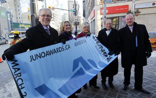 From left, Premier Greg Selinger, Melanie Berry, president & CEO, CARAS/The JUNO Awards, Carole Vivier 2014 JUNO Host Committee Co-Chair, Mayor Sam Katz and Kenny Boyce, 2014 JUNO Host Committee Co-Chair  pose with a JUNO banner on Portage Ave.prior to the   news conference to announce the JUNO  Week details at the Metropolitan Entertainment Centre Tuesday morning.  Wayne Glowacki / Winnipeg Free Press Feb. 25   2014