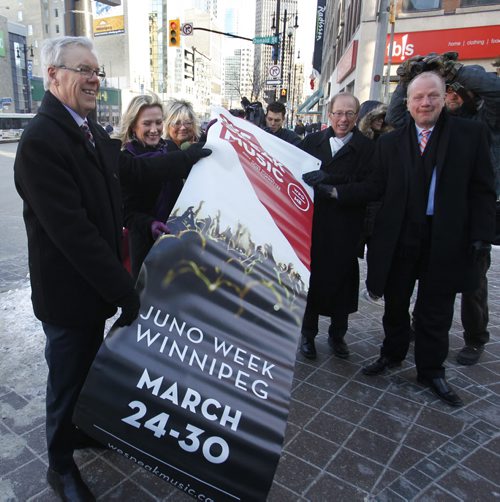 From left, Premier Greg Selinger, Melanie Berry, president & CEO, CARAS/The JUNO Awards, Carole Vivier 2014 JUNO Host Committee Co-Chair, Mayor Sam Katz and Kenny Boyce, 2014 JUNO Host Committee Co-Chair  pose with a JUNO banner on Portage Ave.prior to the   news conference to announce the JUNO  Week details at the Metropolitan Entertainment Centre Tuesday morning.  Wayne Glowacki / Winnipeg Free Press Feb. 25   2014