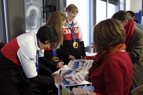 Jill Officer (forground) of the Canadian Women's Gold medal curling team signs autographs at the Winnipeg Free Press News Cafe after a Q&A interview with reporter Geoff Kirbyson Tuesday afternoon. 140225 - Tuesday, February 25, 2014 -  (MIKE DEAL / WINNIPEG FREE PRESS)