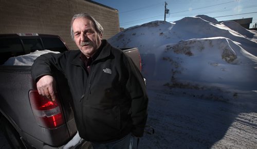 Gino Riccio poses in front of the evidence, he caught city snow clearing crews dumping snow in his parking lot and has them on surveillance tape. See Adam Wazney's story February 25, 2014 - (Phil Hossack / Winnipeg Free Press)