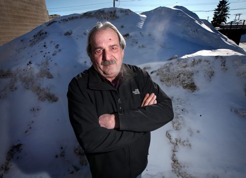 Gino Riccio poses in front of the evidence, he caught city snow clearing crews dumping snow in his parking lot and has them on surveillance tape. See Adam Wazney's story February 25, 2014 - (Phil Hossack / Winnipeg Free Press)