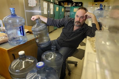 Kurt Shmon, president, Imperial Seed. sits next to empty water jugs that need to be refilled from outside his business throughout the day in order to continue operating his business that is without water due to frozen water lines across the street from his business. See Aldo's story. Ruth Bonneville / Winnipeg Free Press