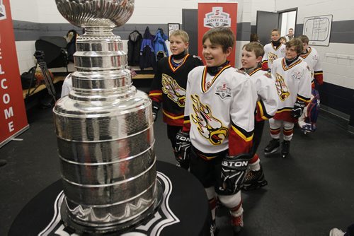 February 25, 2014 - 140225  -  Members the Fort Garry Flyers 9A1 team enter a dressing room to take a close look at the Stanley Cup at MTS Iceplex Tuesday, February 25, 2014. The team was selected for this event because of their volunteer work. John Woods / Winnipeg Free Press
