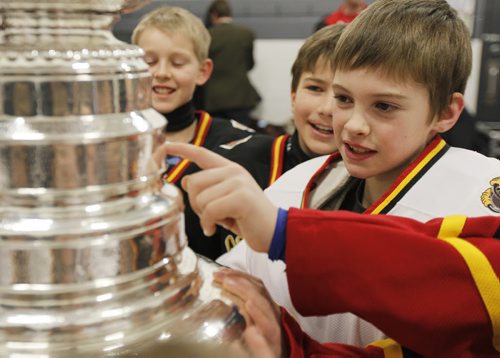 February 25, 2014 - 140225  - Carson Fischer and the Fort Garry Flyers 9A1 team takes a close look at the Stanley Cup at MTS Iceplex Tuesday, February 25, 2014. The team was selected for this event because of their volunteer work. John Woods / Winnipeg Free Press
