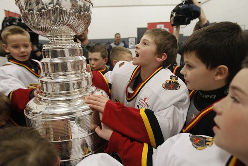 February 25, 2014 - 140225  -  Members of the Fort Garry Flyers 9A1 team take a close look at the Stanley Cup at MTS Iceplex Tuesday, February 25, 2014. The team was selected for this event because of their volunteer work. John Woods / Winnipeg Free Press