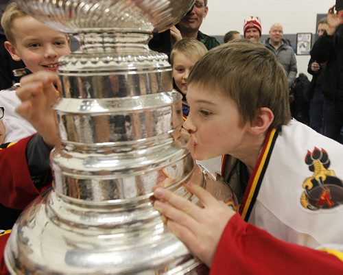 February 25, 2014 - 140225  - Carson Fischer of the Fort Garry Flyers 9A1 team kisses the Stanley Cup at MTS Iceplex Tuesday, February 25, 2014. The team was selected for this event because of their volunteer work. John Woods / Winnipeg Free Press