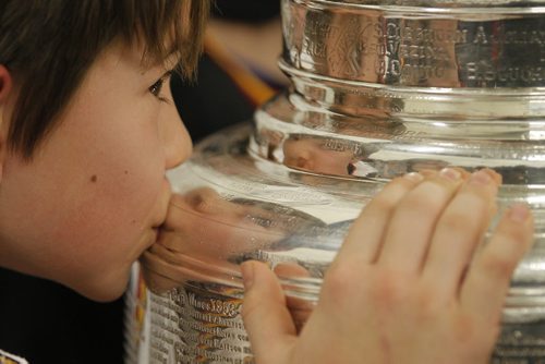 February 25, 2014 - 140225  -  Luke Carlson of the Fort Garry Flyers 9A1 team kisses the Stanley Cup at MTS Iceplex Tuesday, February 25, 2014. The team was selected for this event because of their volunteer work. John Woods / Winnipeg Free Press