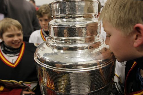February 25, 2014 - 140225  -  Kyle Schepens of the Fort Garry Flyers 9A1 team kisses the Stanley Cup at MTS Iceplex Tuesday, February 25, 2014. The team was selected for this event because of their volunteer work. John Woods / Winnipeg Free Press