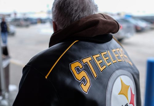Cathy Hurd and Tom Carter have been together for 16 years. Last year Tom was diagnosed with frontotemporal dementia, a disease that will eventually take Tom's life. This past Valentines weekend photographer Mike Deal spent an afternoon with them talking about love and their relationship. His brother gave him this Pittsburg Steelers jacket just the day before, Tom's favorite sporting teams are the Steelers and the Boston Bruins. Watching sports on TV is one of his favorite pastimes. 140216 February 16, 2014 MIKE DEAL / WINNIPEG FREE PRESS