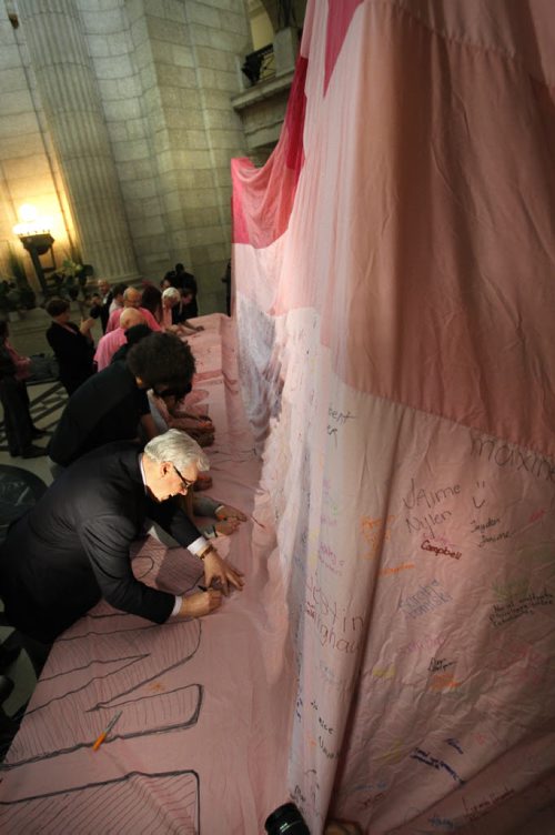 On National Pink Shirt Day, Premier Greg Selinger adds his signature to join the more than 7000 people who have already signed the 9.7 metre by 12.8 metre anti-bullying blanket that was on display in the Manitoba Legislative building Wednesday.  Education and Advanced Learning Minister James Allum outlined the province's anti bullying action plan, he was among the speakers at the event. Brandon University's Anti-Bullying Society members have been gathering signatures on the blanket for over a year brought in the blanket.    Wayne Glowacki / Winnipeg Free Press Feb. 26   2014