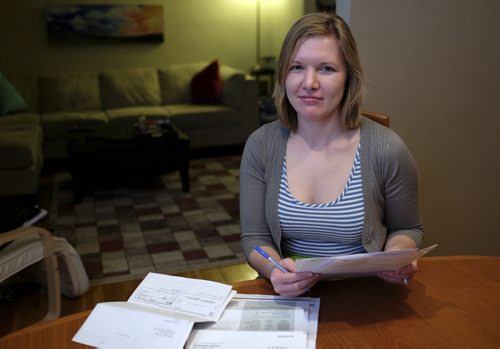 Kelly Hall at her dining room table is upset with a large mutual fund firm that she would have had to pay deferred sales charges to on her RRSP if she had used money from it as a down payment on a home. She doesn't feel she was properly informed about the fees when she purchased the funds five years ago and wants other young investors to be aware of the potential unwanted costs. 140226 - Wednesday, February 26, 2014 -  (MIKE DEAL / WINNIPEG FREE PRESS)