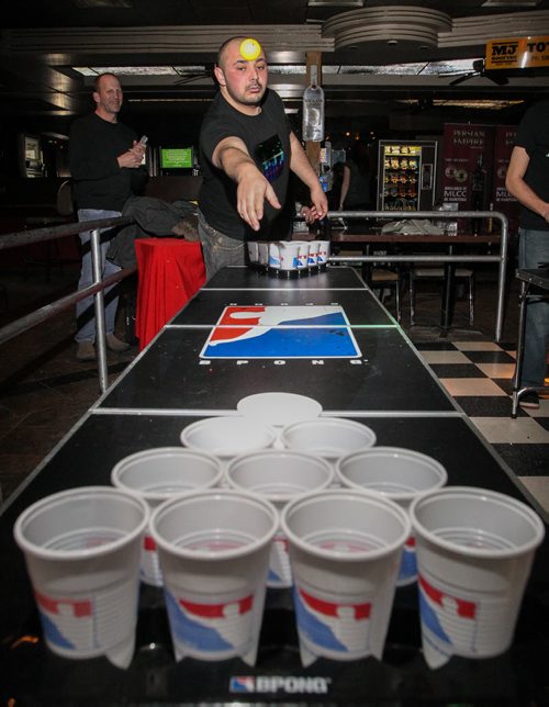 A group of locals are introducing competitive beer pong to Winnipeg, minus the beer. The Pegcitypongers meet at the St. Boniface Hotel every Sunday to play, there are even tournaments. Justin Swain, one of the owners of Pegcitypongers, throws a ping pong ball during a game. 140226 - Wednesday, February 26, 2014 -  (MIKE DEAL / WINNIPEG FREE PRESS)