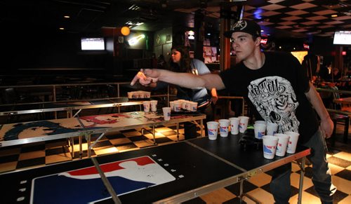 A group of locals are introducing competitive beer pong to Winnipeg, minus the beer. The Pegcitypongers meet at the St. Boniface Hotel every Sunday to play, there are even tournaments. Samuel Chartier throws a ping pong ball during a game. 140226 - Wednesday, February 26, 2014 -  (MIKE DEAL / WINNIPEG FREE PRESS)
