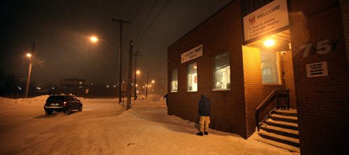 A client smoles outside  the Main Street Project Thursday evening. See Randy Turner's tale re: Homelessness.  January 23, 2014 - (Phil Hossack / Winnipeg Free Press)