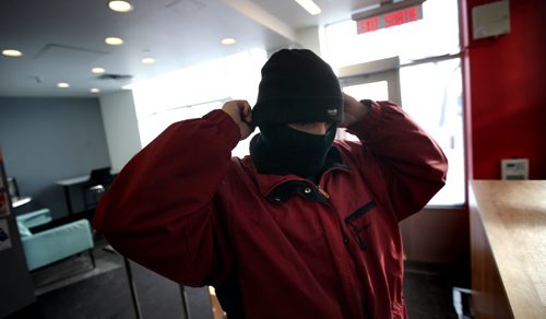 "Jonah" a resident at the Bell Hotel where the Main Street Project works a "Harm Reduction" program, pulls on a balaclava getting ready to make his daily morning walk to a nearby methadone clinic.  See Randy Turner's Homeless feature. February 20, 2014 - (Phil Hossack / Winnipeg Free Press)