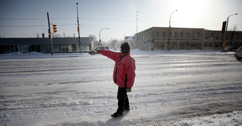 "Jonah" a resident at the Bell Hotel where the Main Street Project works a "Harm Reduction" program,points toward his destination, a  main street methadone clinic, the object of his daily morning walk.  See Randy Turner's Homeless feature. February 20, 2014 - (Phil Hossack / Winnipeg Free Press)