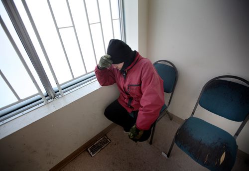 "Jonah" a resident at the Bell Hotel where the Main Street Project works a "Harm Reduction" program, warms himself at a main street methadone clinic before trekking back to the "Bell". See Randy Turner's Homeless feature. February 20, 2014 - (Phil Hossack / Winnipeg Free Press)