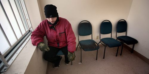 "Jonah" a resident at the Bell Hotel where the Main Street Project works a "Harm Reduction" program, warms himself at a main street methadone clinic before trekking back to the "Bell". See Randy Turner's Homeless feature. February 20, 2014 - (Phil Hossack / Winnipeg Free Press)