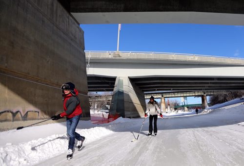 Skaters under the Main Street Bridge along the River Trail near The Forks, Friday, February 28, 2014. (TREVOR HAGAN/WINNIPEG FREE PRESS)