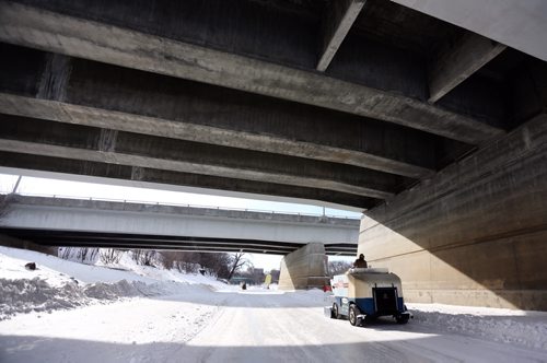 An ice cleaner drives under the Main Street Bridge along the River Trail near The Forks, Friday, February 28, 2014. (TREVOR HAGAN/WINNIPEG FREE PRESS)