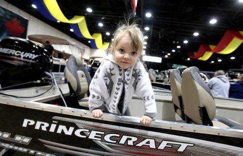 Three year old Karmyn Wiebe checks out a fishing boat  while attending the Mid-Canada Boat Show at the Convention Centre with her family Saturday. Standup Photo  March 01, 2014 Ruth Bonneville / Winnipeg Free Press