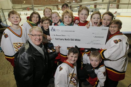 March 1, 2014 - 140301  -  Derek Turner, a sales representative with Canadian Scholarship Trust (CST), presents a cheque for $10000 to the Fort GArry North 10A1 hockey team at Gateway Recreation Centre Saturday, March 1, 2014. John Woods / Winnipeg Free Press