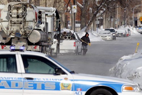 Water crews try to fix flooded Edmonton street just north of Ellice ave.  Police have streets blocked off and are encouraging people to stay clear of the area.  BORIS MINKEVICH / WINNIPEG FREE PRESS  Feb. 28/14