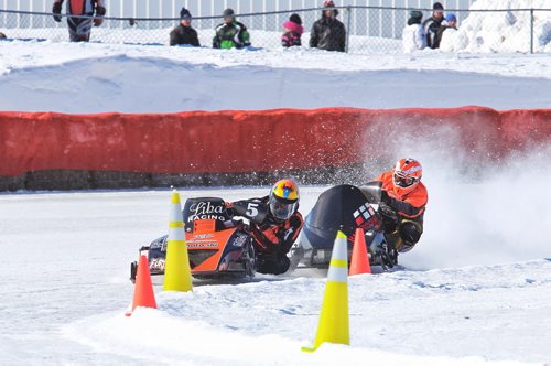 Racers make their way around the half-mile ice oval in Beausejour, MB during the 52nd annual Canadian Power Toboggan Championships Sunday afternoon.   140302 March 2, 2014 Mike Deal / Winnipeg Free Press