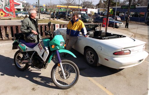 BORIS MINKEVICH/WINNIEPG FREE PRESS MARCH-3-2000 Robert Wilson with his motorcycle and Bill Lucenkiw with his convertable camaro chat about the great weather on Corydon at lunch hour.