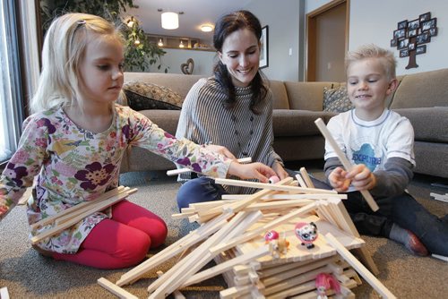 March 2, 2014 - 140302  -  Lorelle Perry plays with her children Micah (R) and Lillia in their home Sunday, March 2, 2014. Perry is a mom and teacher who started a playgroup called KidBridge for newcomer moms and their children to meet established Cdn moms and preschoolers  now theyre the subject of a book and a documentary being screened on International Womens Day this Saturday. John Woods / Winnipeg Free Press. Carol Sanders story