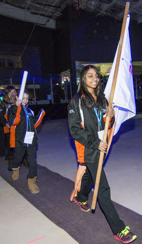 140302 Winnipeg - DAVID LIPNOWSKI / WINNIPEG FREE PRESS - March 02, 2014  Westman flag bearer Nicole Russel (age 13) enters the arena for the opening ceremonies of the 2014 Power Smart Manitoba Games  in Morden, MB Sunday night.