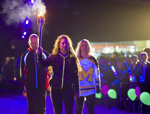140302 Winnipeg - DAVID LIPNOWSKI / WINNIPEG FREE PRESS - March 02, 2014  Torchbearer Keith Peters (left)Amber Wiebe (centre) and Kayleigh Wiens walk with the torch during the opening ceremonies of the 2014 Power Smart Manitoba Games in Morden, MB Sunday night.