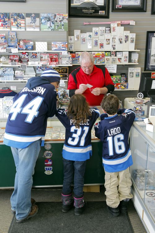 INTERSECTION - Joe Daley's Sports Cards turns 25 this year. Joe played goal for the Jets during the WHA days and opened a sports card shop in town 10 years after he retired. In this photo Joe deals with some unidentified customers. BORIS MINKEVICH / WINNIPEG FREE PRESS  March 3/14