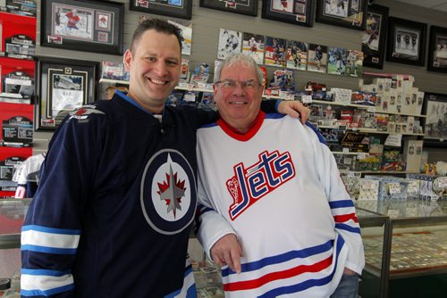 INTERSECTION - Joe Daley's Sports Cards turns 25 this year. Joe played goal for the Jets during the WHA days and opened a sports card shop in town 10 years after he retired. In this photo Joe, right, with his sone Travis, left, pose for a photo in the store. BORIS MINKEVICH / WINNIPEG FREE PRESS  March 3/14