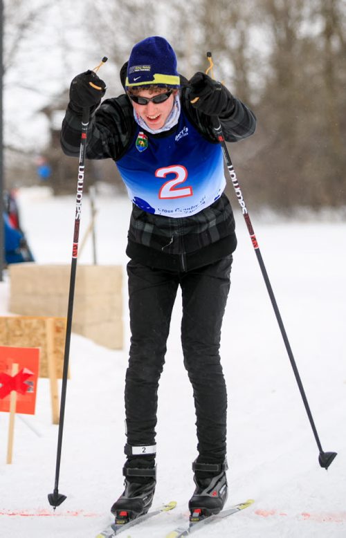 Jesse Bachinsky, 15, smiles as he crosses the finish line of the 7.5km male juvenile cross country ski race, as part of the 2014 Power Smart Manitoba Winter Games at Birch Ski Area in Roseisle, MB. Bachinsky is thought to be the first ever visually impaired athlete to compete in cross country skiing at the Manitoba Games. 140303 - Monday, {month name} 03, 2014 - (Melissa Tait / Winnipeg Free Press)