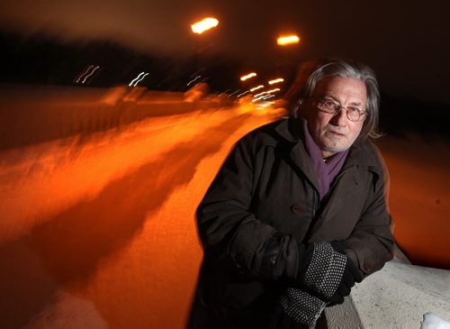 Alden Wiebe stands on the Assinaboine Park pedestrian bridge Monday night. He jumped off the bridge in a desperate attempt to escape his problems while homeless in 2012. See Randy Turner story. March 3, 2014 - (Phil Hossack / Winnipeg Free Press)