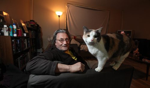 Formerly homeless, Alden Wiebe poses in the small Ellice ave apartment he shares with a partner and two cats. The building is literally being renovated around them. See Randy Turner story. March 3, 2014 - (Phil Hossack / Winnipeg Free Press)