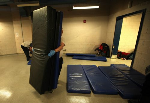 Volunteers lay out mats on the floor for clients to sleep on Thursday evening. See Randy Turner's tale re: Homelessness.  January 23, 2014 - (Phil Hossack / Winnipeg Free Press)