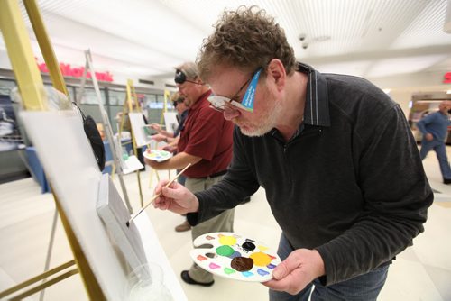 Winnipeg Free Press columnist  Doug Speirs tries to paint a picture of his late Bassett hound, Cooper, at the "Eye on the Arts" Blind Media Painting Challenge at Winnipeg Square Tuesday.  Speirs was wearing a set of glasses (under his own glasses) that prevented him from seeing normally during the event to bring awareness to what it is like to have a vision  disability.   March 04, 2014 Ruth Bonneville / Winnipeg Free Press