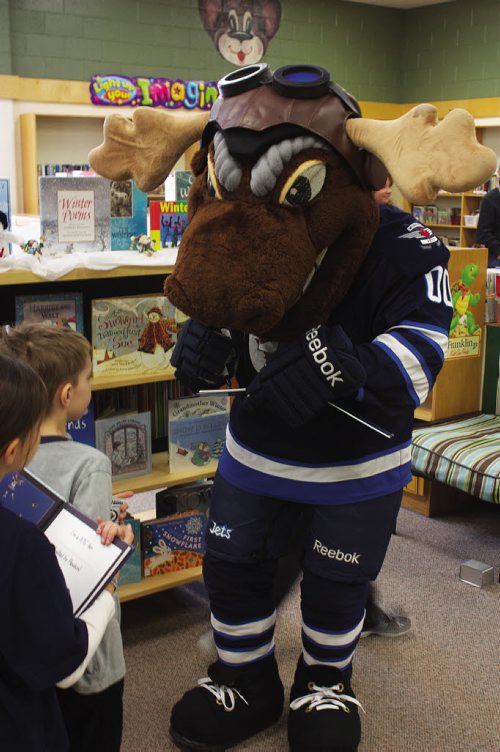 Canstar Community News Feb. 25/14 - Winnipeg Jets mascot Mick E. Moose signs a copy of The Home Team for a young fan at Prince Edward School. Centre Mark Scheifele and defenceman Zach Bogosian also attended the I Love to Read Month event through the team's Reading Takes Flight program. (DAN FALLOON/CANSTAR COMMUNITY NEWS/HERALD)