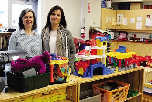 Canstar Community News (03/03/2014)- Gayle Waxman (left), executive director of Rady JCC, with Eleonora Caporalini, director of child care services at Rady JCC, at the Rady JCC's daycare. The two are celebrating after the community centre was awarded the fire hall on Grosvenor Ave.  from the city of Winnipeg. (STEPHCROSIER/CANSTARNEWS)