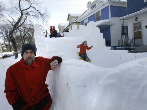 Home Street resident David Neyedli by his giant ice castle/slide in the front yard of his home that he built for the neighbourhood children. He dedicated this year's "bigger and better" version to his neighbour Carla Stefansson who died of cancer on Jan. 10, 2014 and watched him build it from her window above as she fought the disease.Ashley Prest story   Wayne Glowacki / Winnipeg Free Press March 4   2014