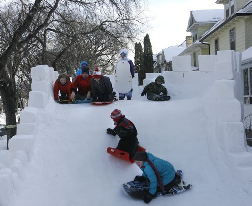 Home Street resident David Neyedli on his giant ice castle/slide in the front yard of his home that he built for the neighbourhood children. He dedicated this year's "bigger and better" version to his neighbour Carla Stefansson who died of cancer on Jan. 10, 2014 and watched him build it from her window above as she fought the disease.Ashley Prest story   Wayne Glowacki / Winnipeg Free Press March 4   2014